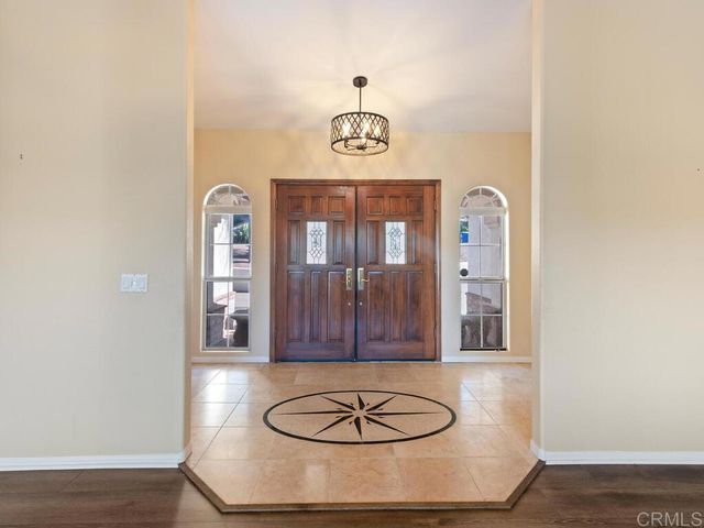 a living room with fireplace furniture and a large window