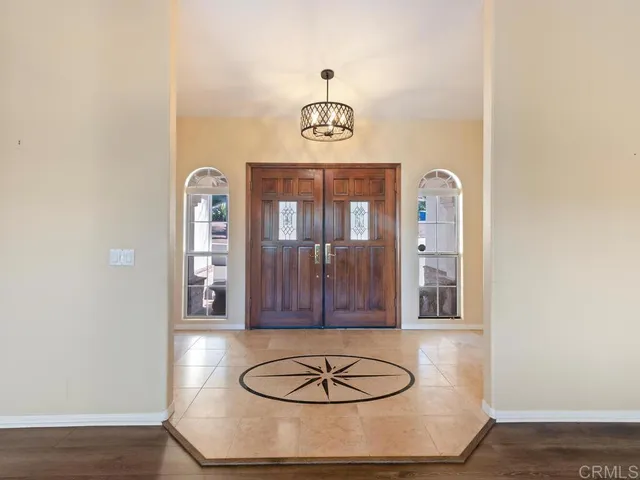 a living room with fireplace furniture and a large window