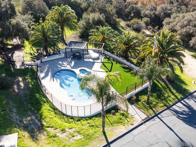 an aerial view of a house with a garden and plants