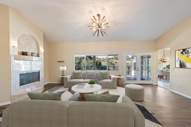 an empty room with floor to ceiling windows and fireplace