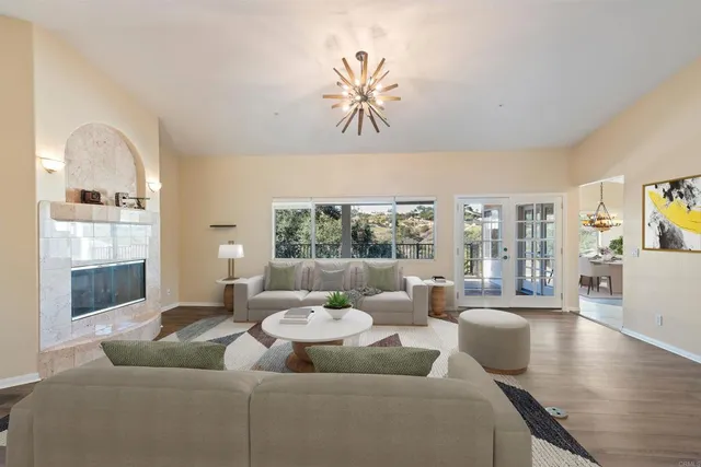 an empty room with floor to ceiling windows and fireplace