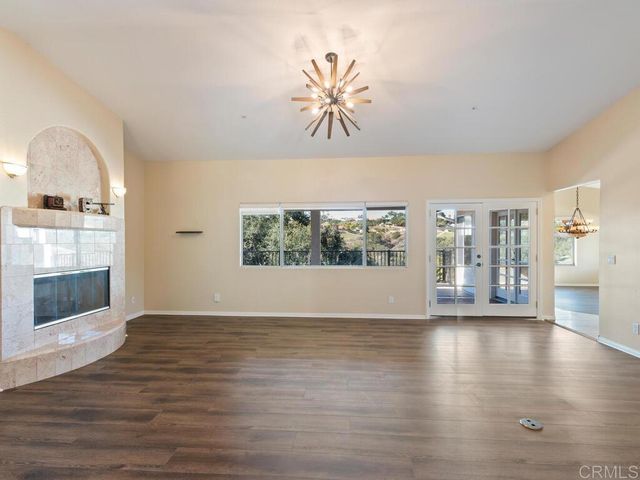 a kitchen with stainless steel appliances granite countertop a sink and wooden cabinets
