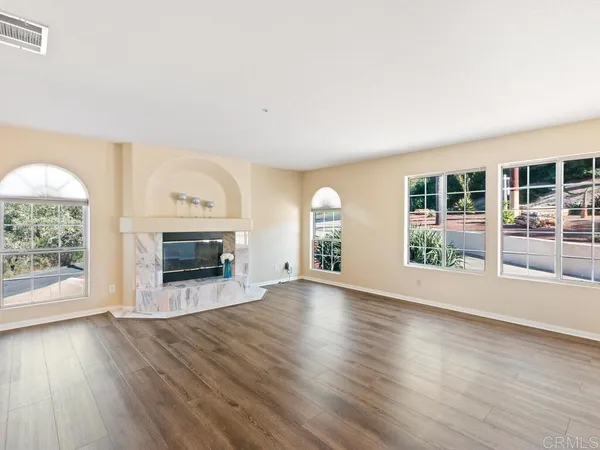 a kitchen with stainless steel appliances kitchen island granite countertop a stove top oven a sink a dining table and chairs