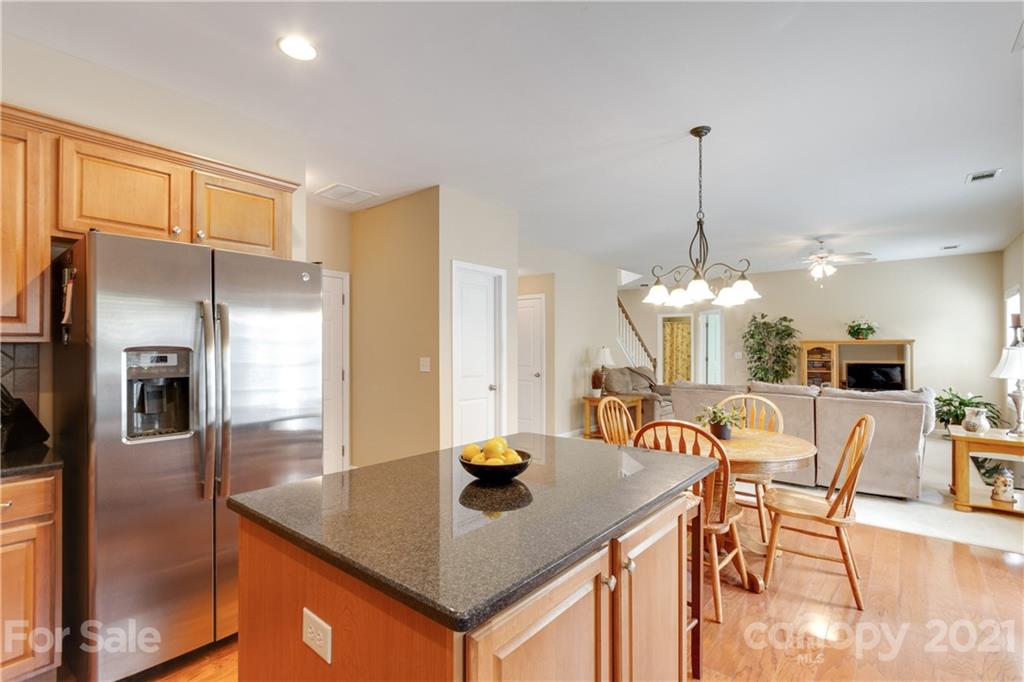 2007 Potomac Road Indian Trail, NC 28079 - Photo 11 of 29 a kitchen with stainless steel appliances granite countertop a kitchen island a cabinetry a stove and a refrigerator