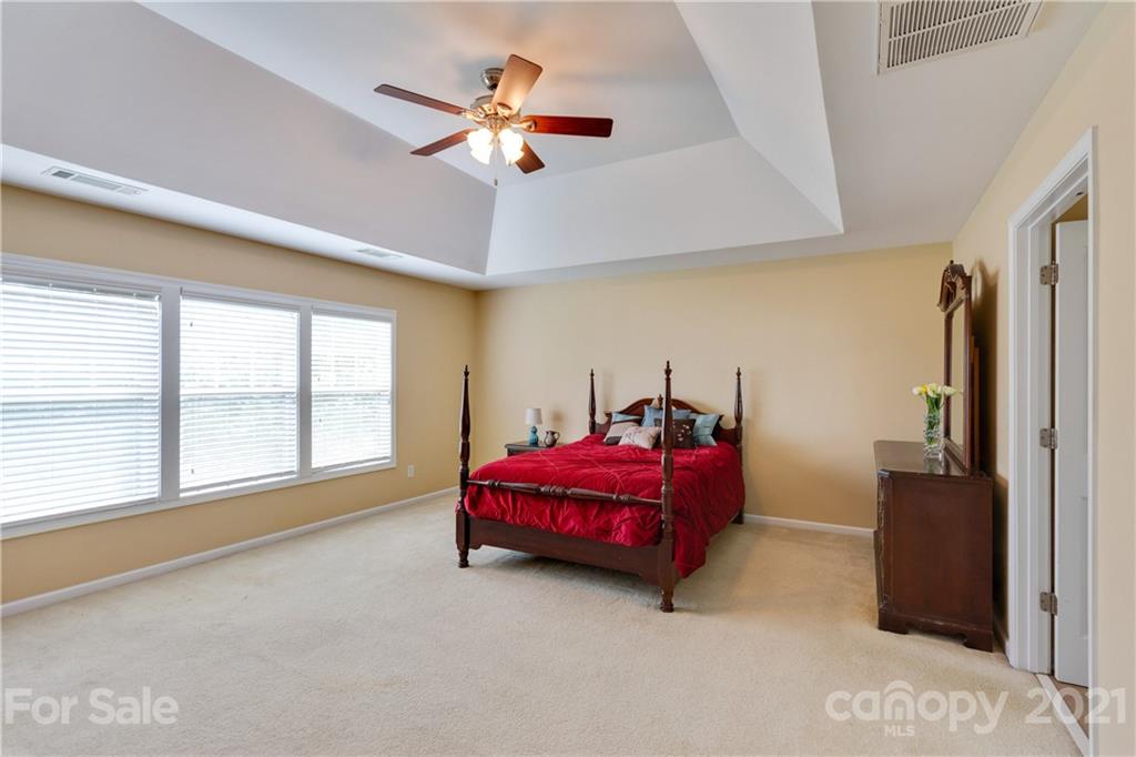 2007 Potomac Road Indian Trail, NC 28079 - Photo 15 of 29 a spacious bedroom with a bed and a chandelier
