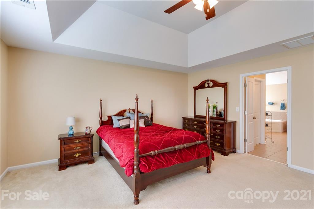 2007 Potomac Road Indian Trail, NC 28079 - Photo 16 of 29 a bedroom with a bed and a chandelier
