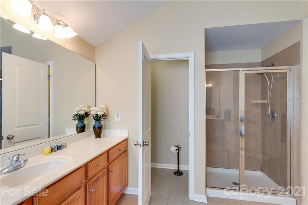 2007 Potomac Road Indian Trail, NC 28079 - Photo 18 of 29 a bathroom with a double vanity sink mirror and shower