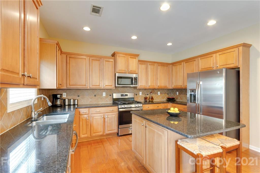 2007 Potomac Road Indian Trail, NC 28079 - Photo 9 of 29 a kitchen with a sink a counter top space stainless steel appliances and cabinets