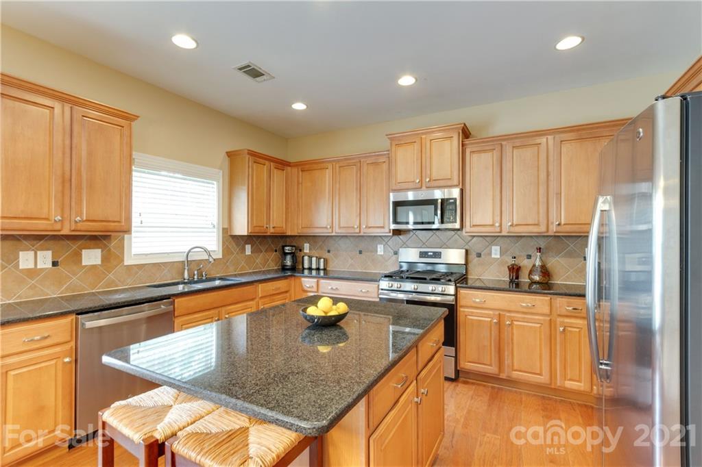 2007 Potomac Road Indian Trail, NC 28079 - Photo 10 of 29 a kitchen with stainless steel appliances granite countertop a sink stove and refrigerator