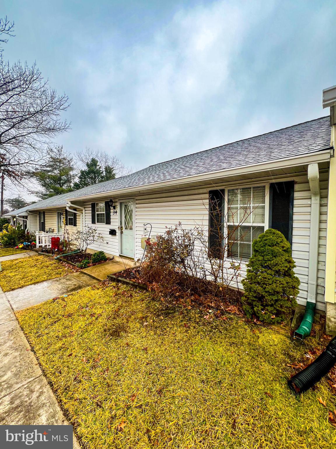 a front view of house with small garden and swimming pool