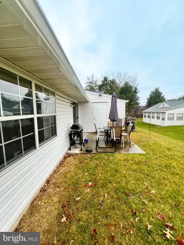 a backyard of a house with table and chairs