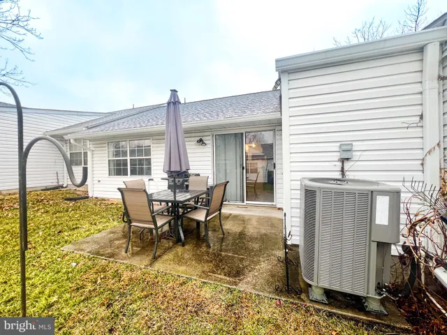 a outdoor sitting area with furniture and wooden floor