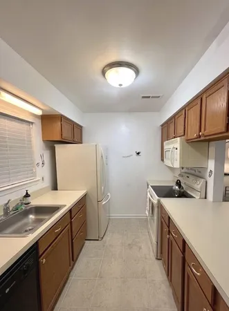 a kitchen that has a sink and a stove