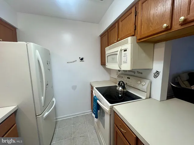 a kitchen with stainless steel appliances a refrigerator a sink a stove and cabinets