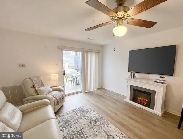 a living room with furniture fireplace and flat screen tv