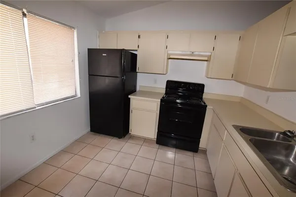 a kitchen with a refrigerator and a stove