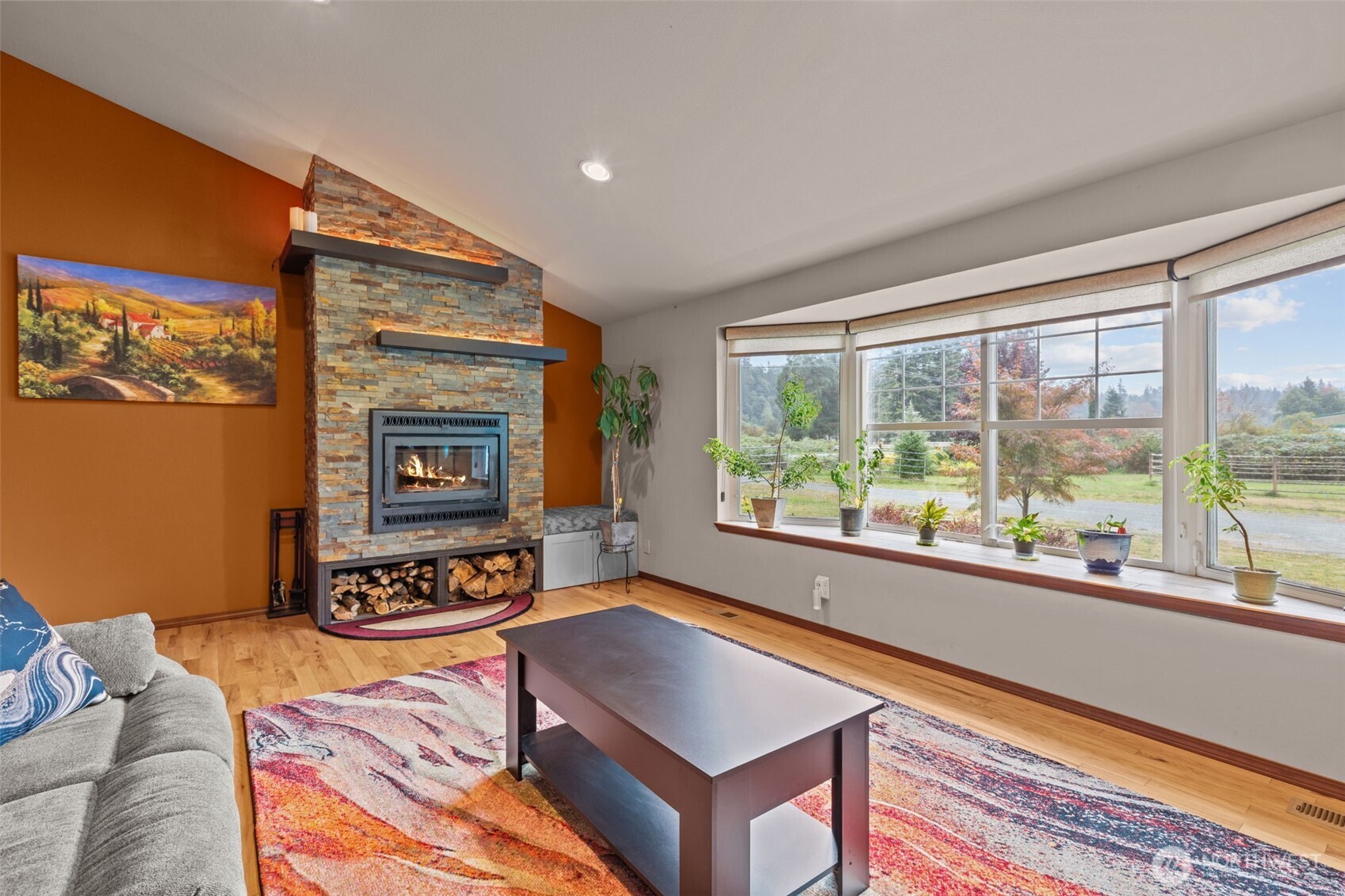 13314 Yeager Road Monroe, WA 98272 - Photo 4 of 40 a living room with furniture a flat screen tv and a floor to ceiling window