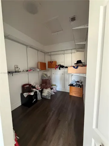 a kitchen with a sink and dishwasher a stove with wooden floor