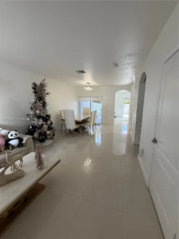 a lobby with furniture and flowers