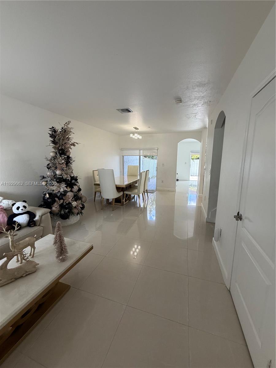 956 Southwest 148th Place Miami, FL 33194 - Photo 2 of 15 a lobby with furniture and flowers