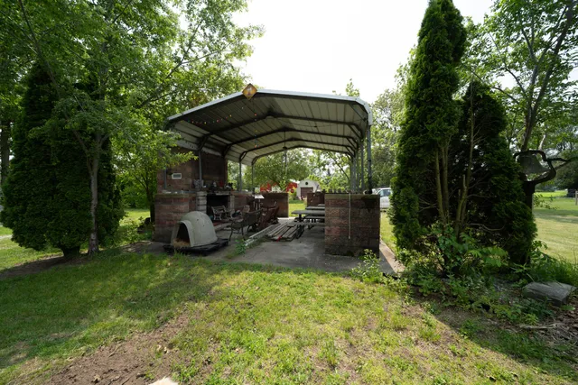 a view of a chair and table in the garden