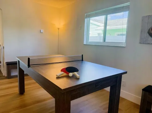 a room with pool table and window