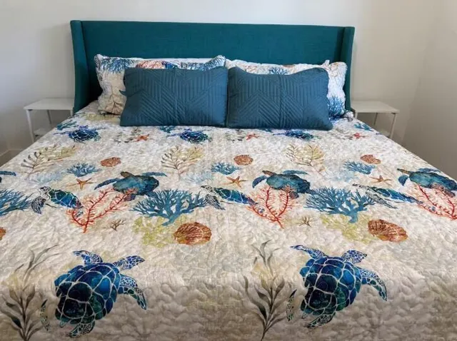 a bed sitting in a bedroom next to a lamp