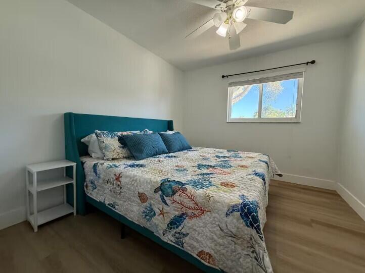 516 East Whitney Drive Jupiter, FL 33458 - Photo 13 of 47 a bedroom with a bed and a window