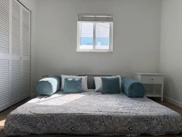 a bedroom with a bed and window
