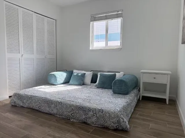 a bedroom with a bed and a window