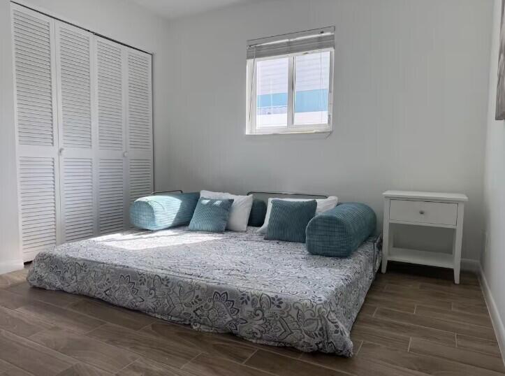 516 East Whitney Drive Jupiter, FL 33458 - Photo 23 of 47 a bedroom with a bed and a window