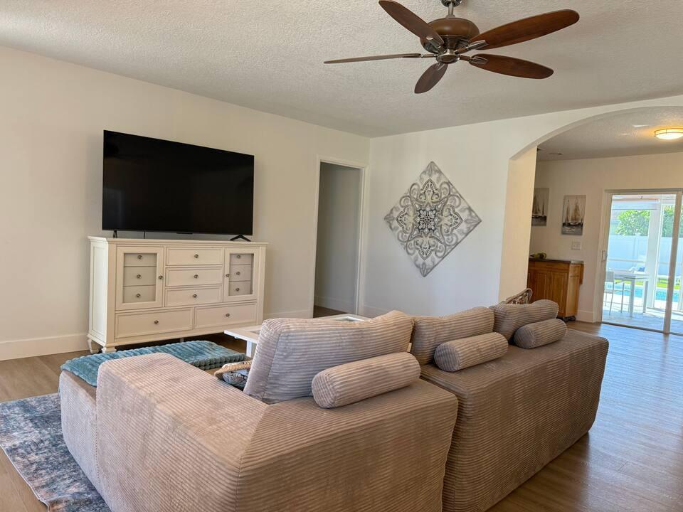 516 East Whitney Drive Jupiter, FL 33458 - Photo 3 of 47 a living room with furniture and a flat screen tv