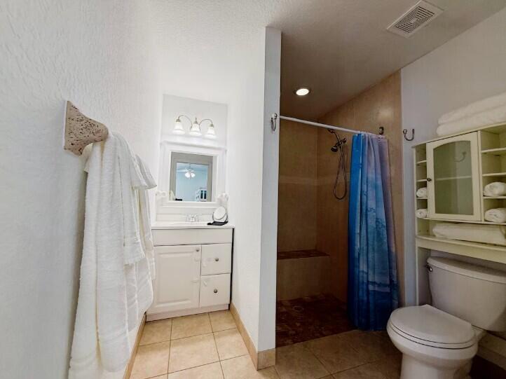 516 East Whitney Drive Jupiter, FL 33458 - Photo 31 of 47 a bathroom with a shower a sink and a toilet