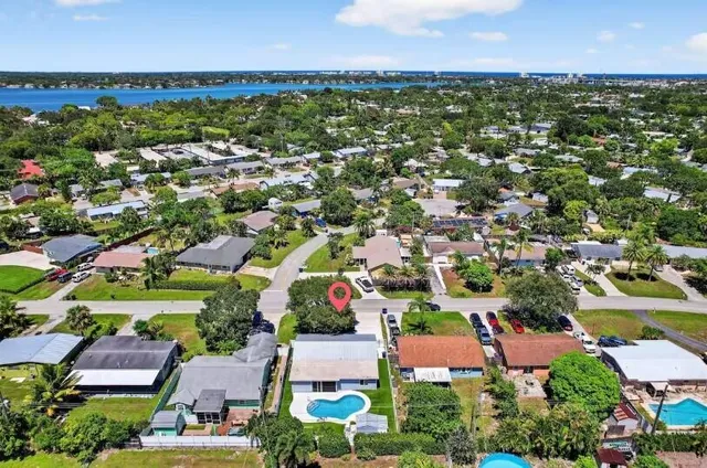 an aerial view of residential houses with outdoor space and street view