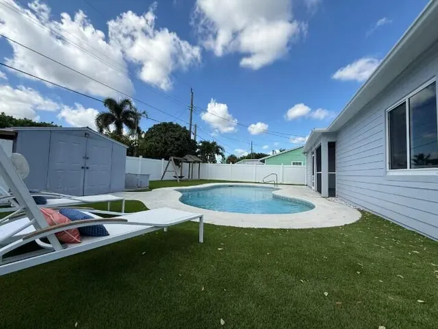 a backyard of a house with table and chairs
