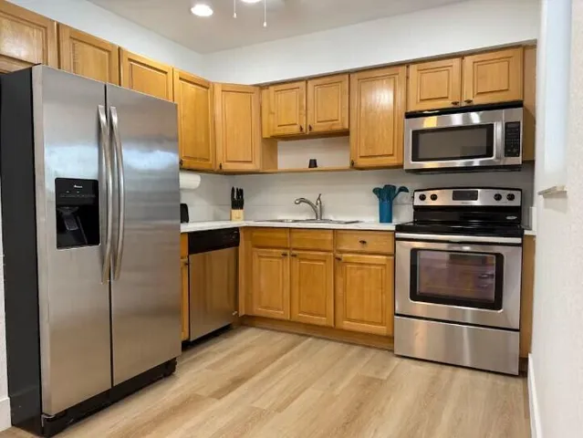 a kitchen with a refrigerator stove and microwave