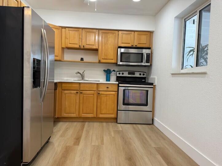 516 East Whitney Drive Jupiter, FL 33458 - Photo 7 of 47 a kitchen with stainless steel appliances granite countertop a stove a sink and a refrigerator