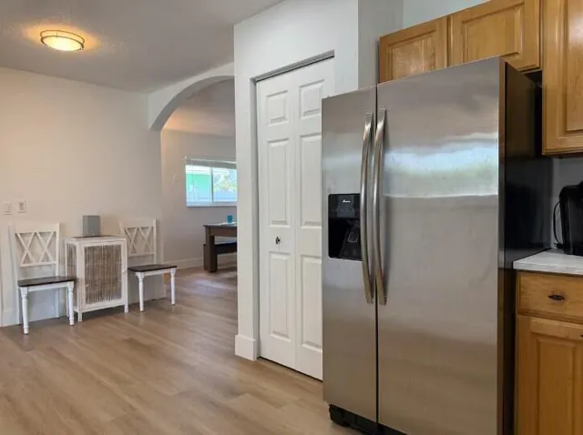 a kitchen with stainless steel appliances refrigerator and microwave