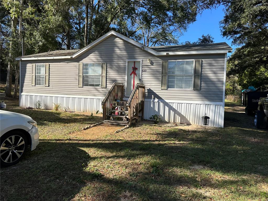 640 Southeast 10th Street Williston, FL 32696 - Photo 1 of 13 a view of a house with backyard