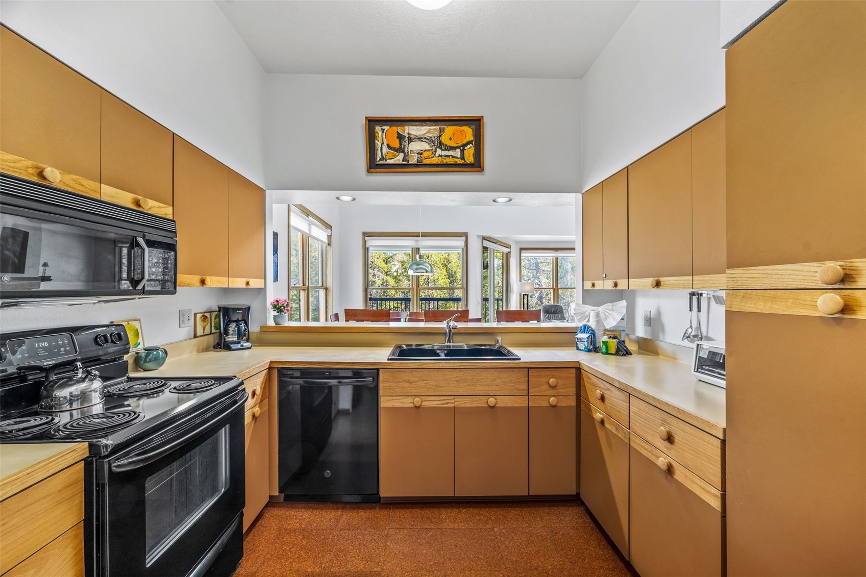 240 Tennis Club Road, Unit 1677 Keystone, CO 80435 - Photo 17 of 46 Kitchen featuring black appliances, a sink, light countertops, a high ceiling, and a peninsula