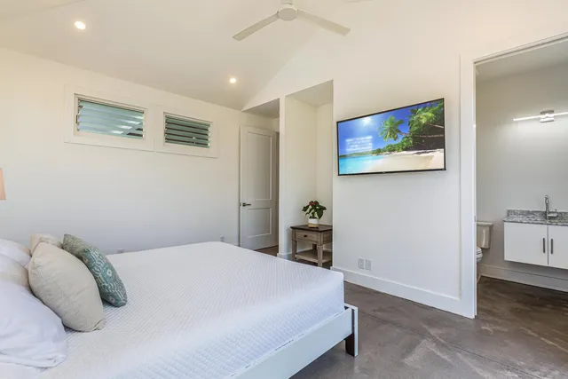 a bedroom with a bed and a painting on the wall