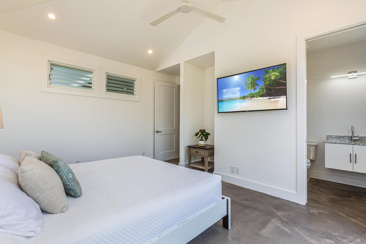 3868 Punahele Road Princeville, HI 96722 - Photo 16 of 24 a bedroom with a bed and a painting on the wall