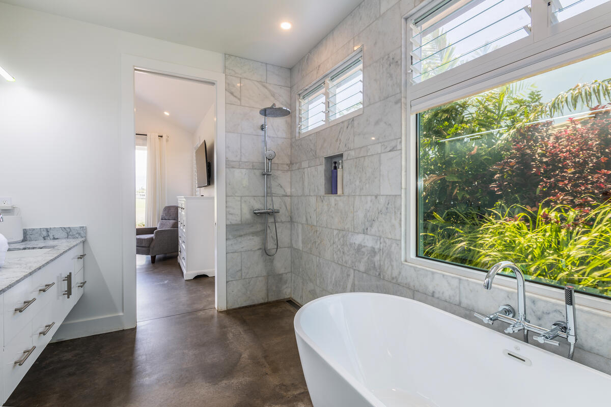 3868 Punahele Road Princeville, HI 96722 - Photo 17 of 24 a bathroom with a granite countertop tub sink and a large mirror