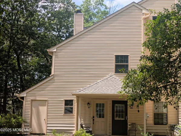 a view of a white house with large windows