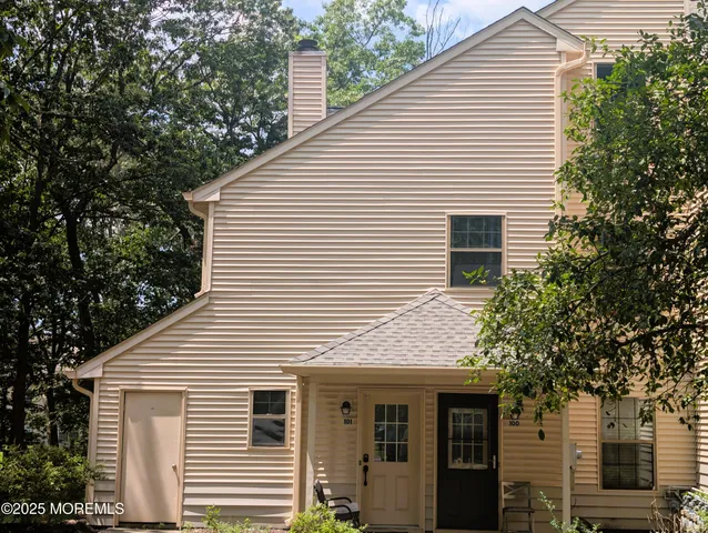 a view of a white house with large windows