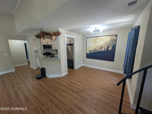 a view of a workspace with furniture and wooden floor