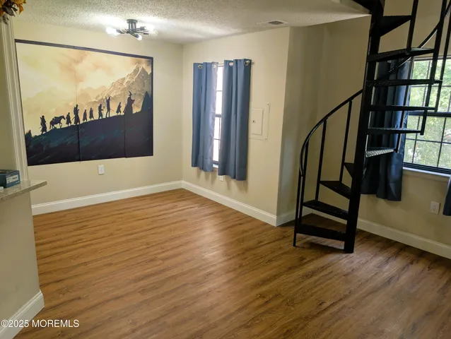 a view of an entryway with wooden floor and door