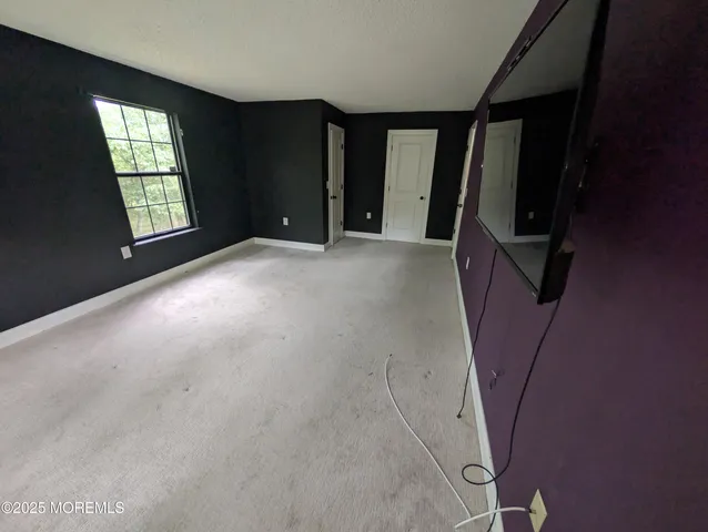 a view of an empty room with windows