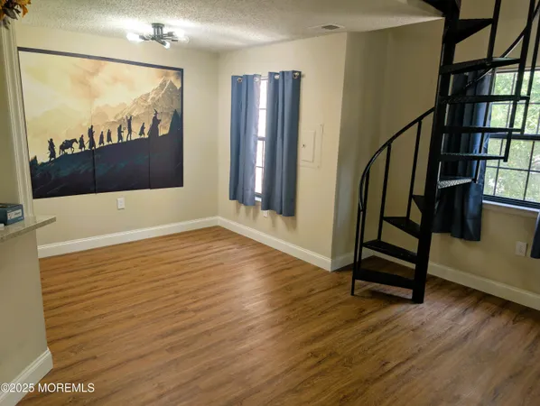 a view of an entryway with wooden floor and door