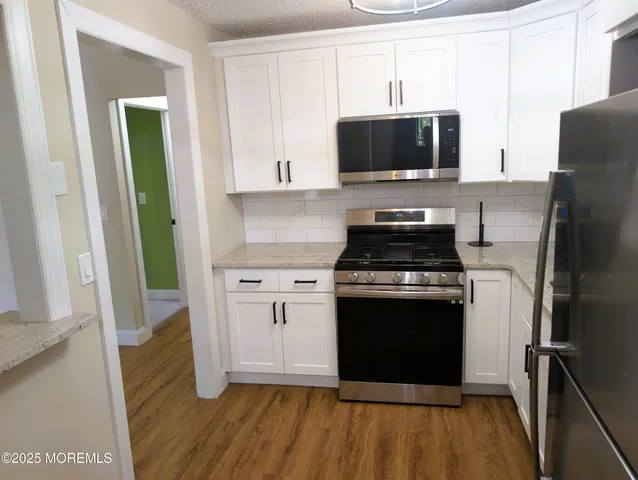 a kitchen with a stove and a microwave